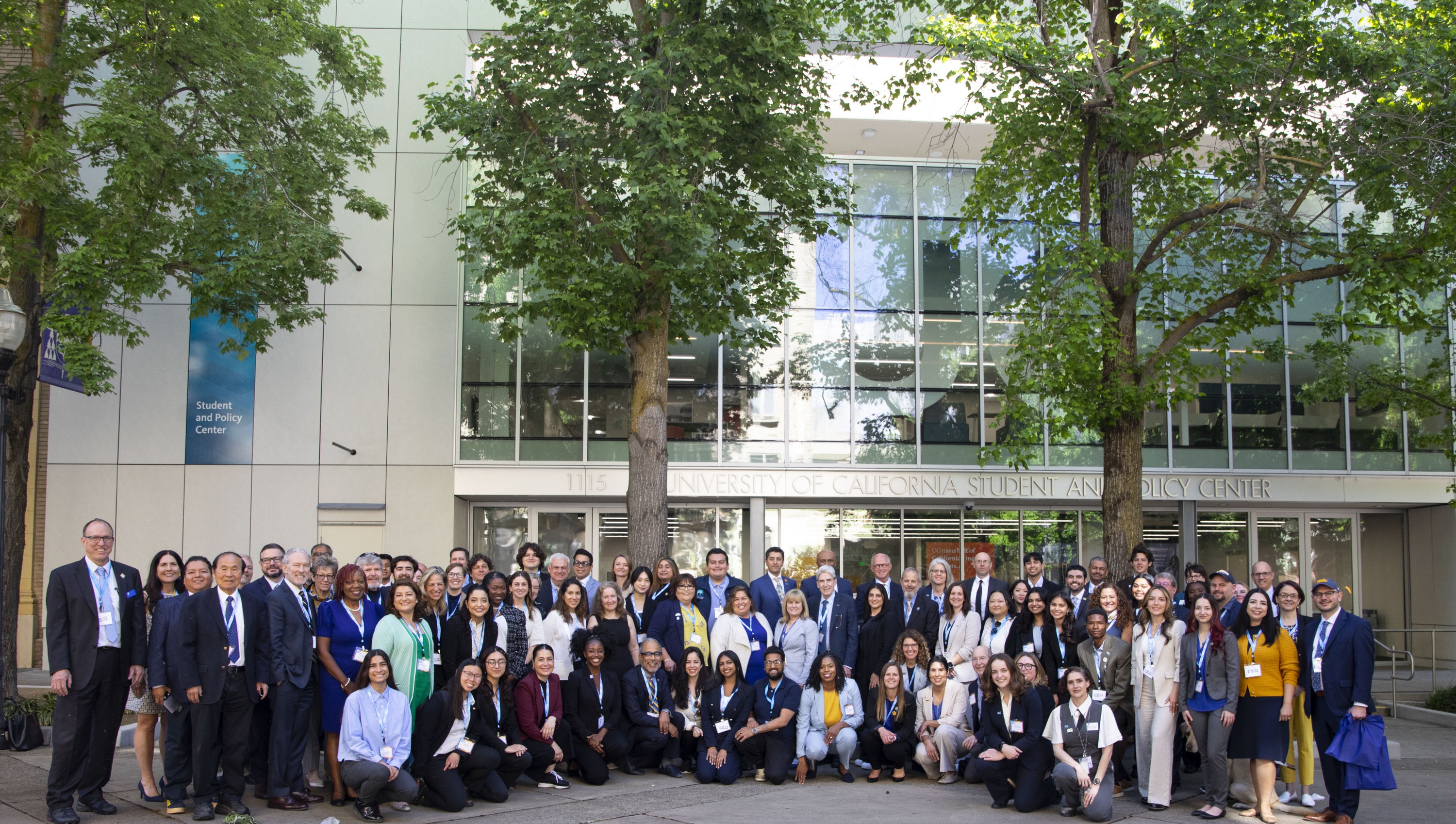 Large group of people outside the entrance of a building.